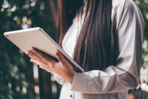 stock image of person holding tablet