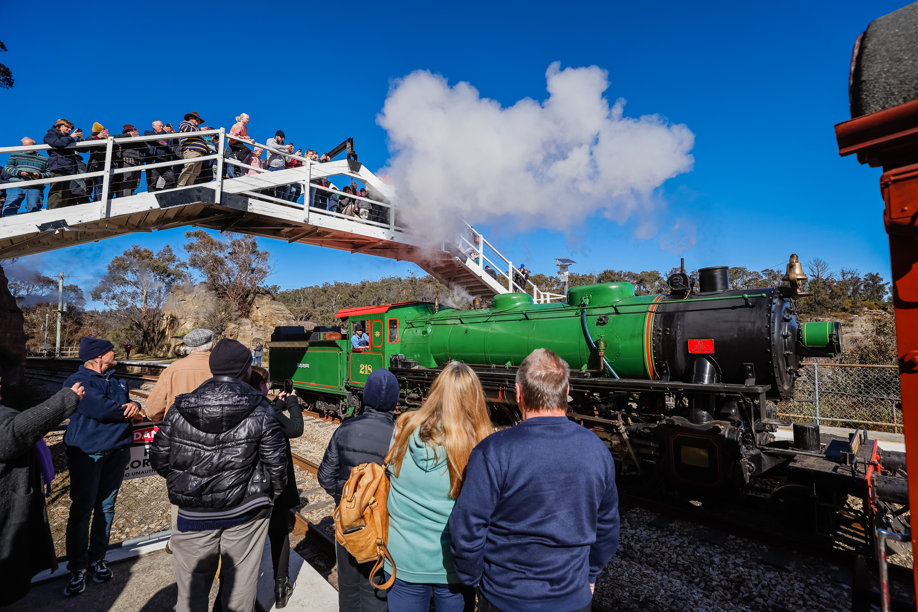 Zig Zag railway opening day, people standing near steam train 